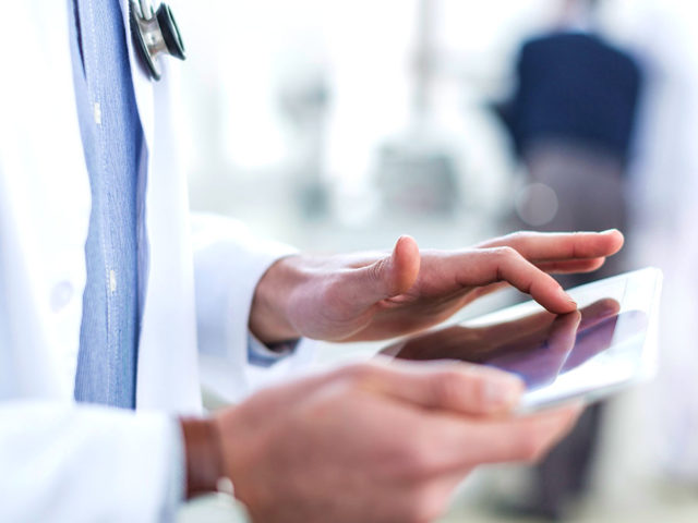 Photo of doctor using tablet